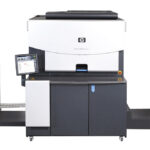 A large printer is shown with the front of it open.