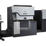 A large printer with two large machines in front of it.