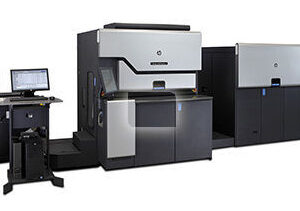 A large printer with two large machines in front of it.