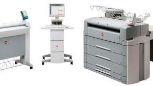 A computer and printer on top of a desk.
