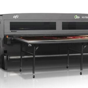 A large sheet metal machine with a table in front of it.