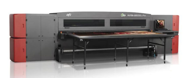 A large sheet metal machine with a table in front of it.