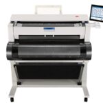 A large printer with a tablet on top of it.
