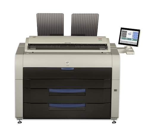 A large printer with two chairs on top of it.