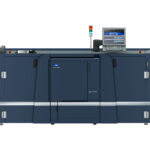 A large printer with two doors open and a monitor on top.