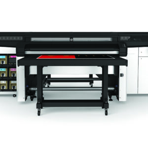 A large printer with many shelves in the background.