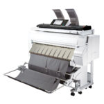 A large printer with two rolls of paper on it.
