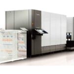 A large machine is shown with papers on the side.