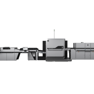A black and white photo of an office with a large printer.