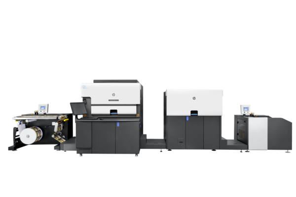 A large printer is shown in front of a black wall.