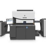 A printer that is sitting in front of some other machines.