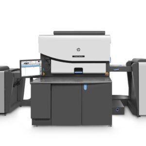 A printer that is sitting in front of some other machines.