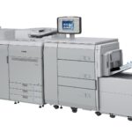 A large printer with two big machines on the side.