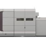 A large printer is shown with the door open.