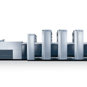 A row of large machines in front of a white wall.