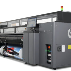 A large printer that is sitting in front of a wall.