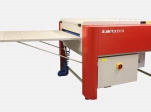 A red and white machine with a table attached to it.